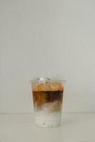 Cold iced latte coffee, showing separate in a layer the bottom as milk top by coffee shot in glass photo