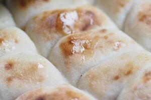 Deliciously Freshly Baked Soft Bread Rolls Topped with a Sweet Glaze photo
