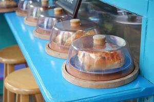 A Showcase of Delicious and Tempting Pastries Under a Glass Cloche Display photo