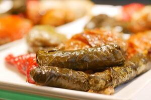 Traditional dolma grape leaves on a plate photo