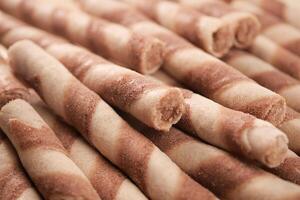 These Delicious Swirled Wafer Rolls are beautifully situated on a Wooden Surface photo