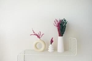 Stylish and Elegant Shelf Decor Featuring Colorful Dried Flowers Arranged in Minimalist Vases photo