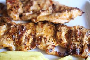 Enjoy a delicious Grilled Chicken Breast seasoned perfectly, served with savory sides photo