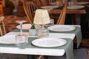 An Elegant Restaurant Table Setting Featuring Beautiful and Decorative Elements and Accents photo