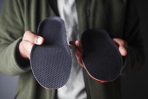 Visual comparison of two shoe insoles showcasing design and texture differences photo
