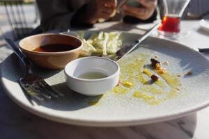 An empty dirty plate with a fork. photo