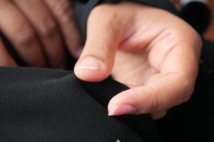 A closeup of a hand gently touching smooth fabric, highlighting comfort and delicate design photo