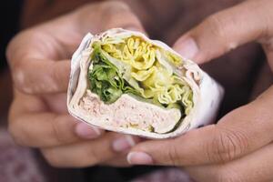 This is a Freshly Made Wrap filled with a variety of Vegetables and lean Turkey meat photo
