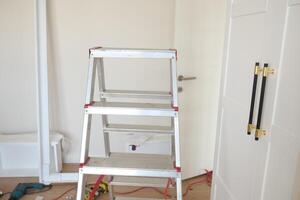 The Complete Home Renovation Process Happening with Ladder and Tools in a Room Setting photo