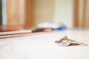 house keys on the ring on table in a room. To forget keys at home concept , photo