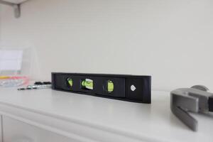 Precision Level Tool Positioned on Shelf Within a Dedicated Workshop Environment Space photo