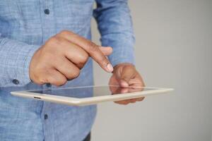 man's hand working on digital tablet on office desk photo