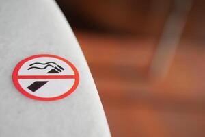 A clear and distinctive No Smoking Sign placed prominently on the table surface photo