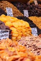 Explore a diverse array of dried fruits and spices at a vibrant market stall for food lovers photo