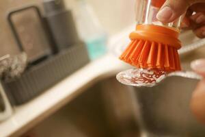 Washing Kitchen Utensils Effectively Using a Brush and Soft Dish Soap for Optimal Clean photo