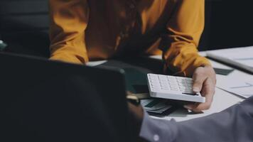 Executives and managers are meeting in a conference room, on the table there are some documents about the company's finances, managers are discussing financial information with the management. video