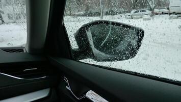 City Yard Parking At Winter Morning. Wet Snow And Cold Drops On The Car Side Window And Mirror photo