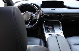 Interior of Modern Car with Ignition Off and Switched Displays. View from Rear Seats on Car Dashboard With Leather Upholstery photo