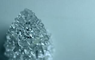 Structure of transparent crystal in the shape of a pyramid with growths tapering at the top photo