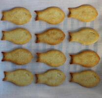 Homemade Fish Shaped Cookies Laid Out In A Rows On Clean White Napkin photo