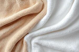 White and peach towels with a soft texture draped in folds photo