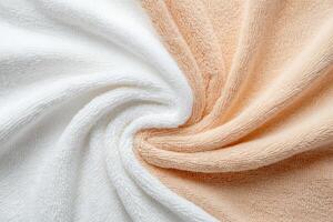 White and peach towels with a soft texture draped in folds photo