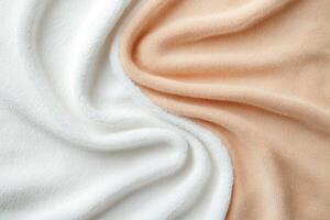 White and peach towels with a soft texture draped in folds photo