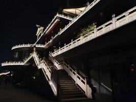 night view of a temple lighted up with neon lighting photo