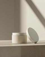 A white cosmetic plastic jar with open lid on a soft shadow beige background mockup photo