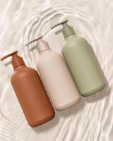 Three different colored bottles of soap on a water ripple background photo