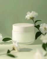 A white cream jar on flowers and plants background packaging mockup photo