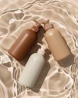 Three bottles of lotion on a sandy surface photo