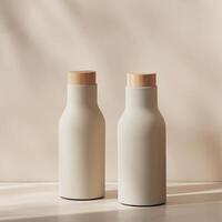 Two white bottles with wooden lids sit on a table photo