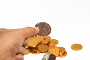 Chocolate coins. Brown coin money background on brown background. Coins are stacked on top of each other in different positions. Bunch of coins. photo