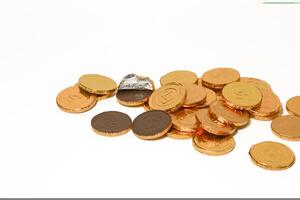 Chocolate coins. Brown coin money background on brown background. Coins are stacked on top of each other in different positions. Bunch of coins. photo