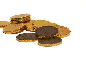 Chocolate coins. Brown coin money background on brown background. Coins are stacked on top of each other in different positions. Bunch of coins. photo