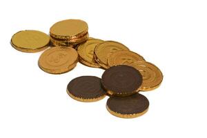 Chocolate coins. Brown coin money background on brown background. Coins are stacked on top of each other in different positions. Bunch of coins. photo