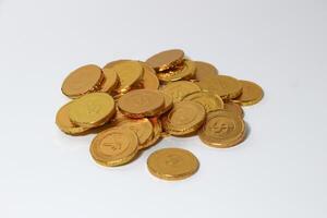 Chocolate coins. Brown coin money background on brown background. Coins are stacked on top of each other in different positions. Bunch of coins. photo