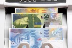Swiss franc in the counting machine photo