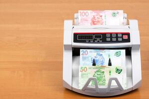 Hong Kong dollar in a counting machine photo