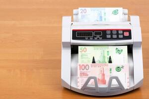 Hong Kong dollar in a counting machine photo