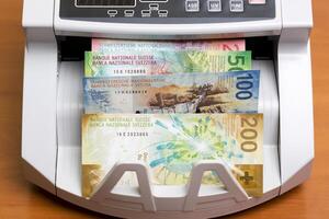 Swiss franc in the counting machine photo