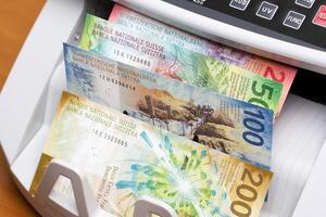 Swiss franc in the counting machine photo