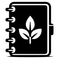 A notebook with a leaf on it vector