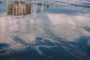 a reflection of houses in sea water photo
