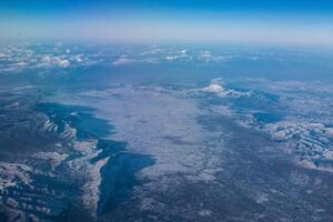 view of mountains covered with snow from an airplane window, Cyprus photo