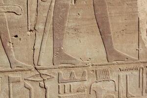 Part of the ancient egyptian scripts and drawings on the wall in Luxor, Egypt. photo
