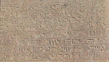 Ancient egyptian hieroglyphs engraved on the wall. photo