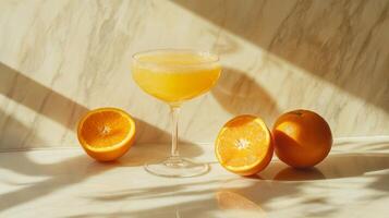 Glass of orange juice with fresh oranges on a marble surface. Refreshing citrus beverage concept photo