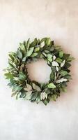 Green leaf wreath on textured wall, rustic home decor concept photo